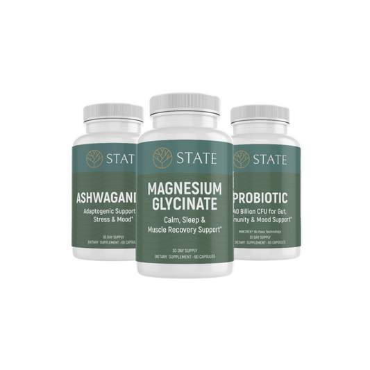 Three supplement bottles labeled Ashwagandha, Magnesium Glycinate, and Probiotic on a white background